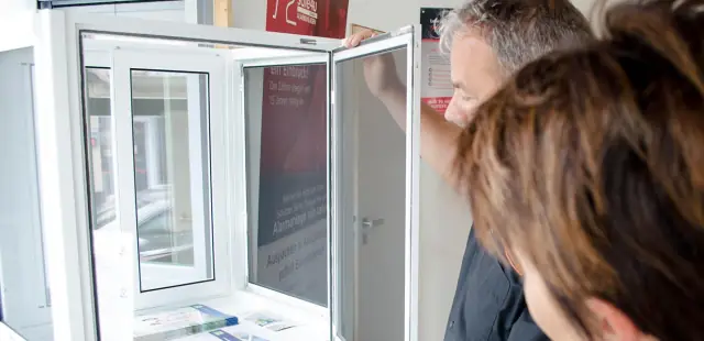 Beratung an einem geöffneten Dreh-Kipp-Fenster